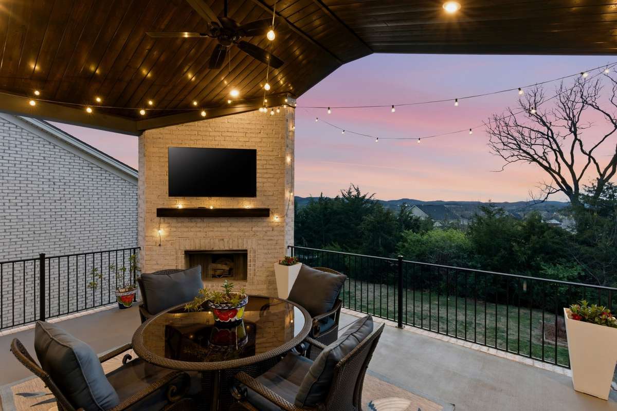 Step out onto this elevated covered deck. The wood ceiling and lighting make it feel like a whole extra living space.