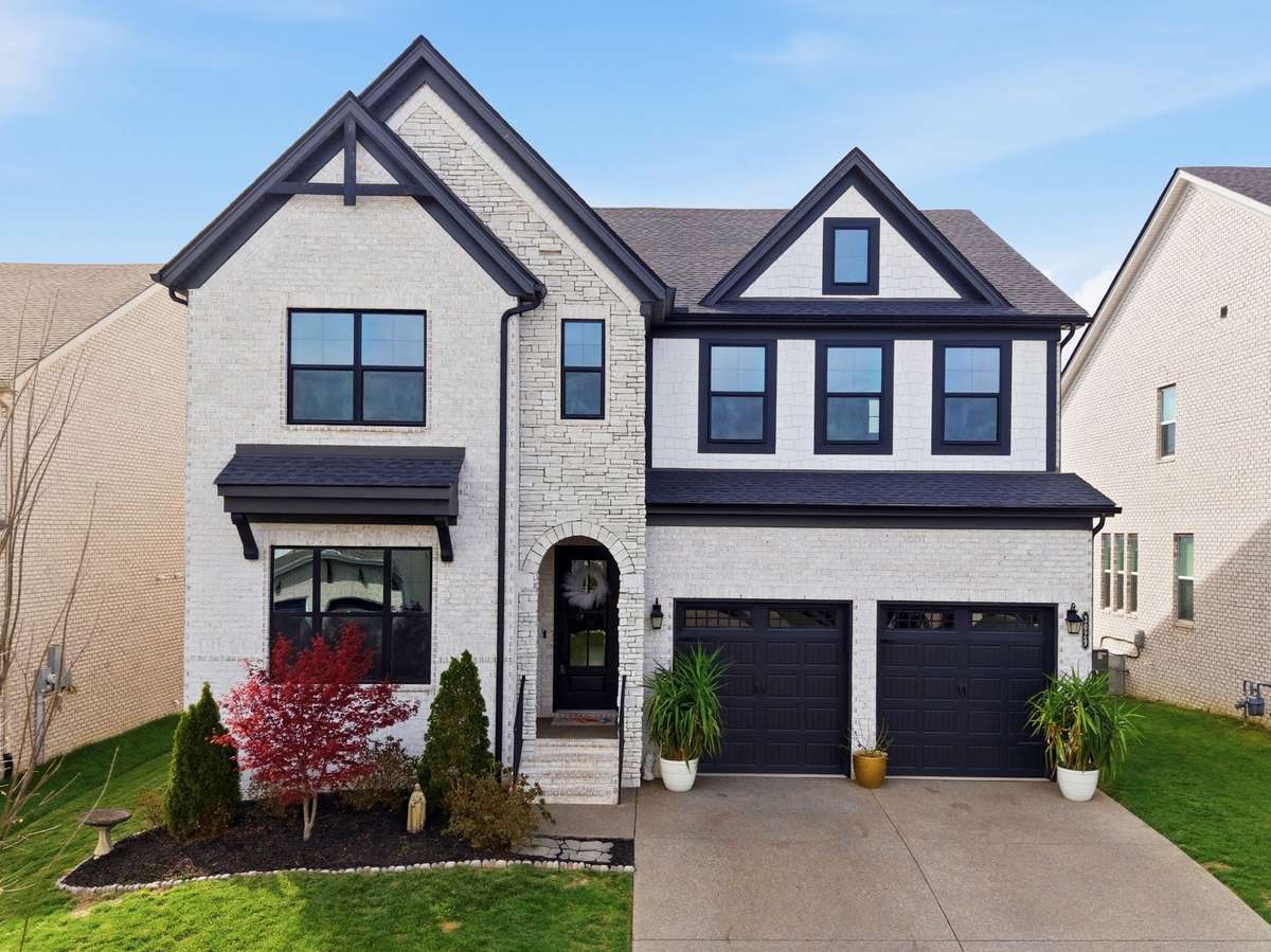 Located in Nolensville, one of the area’s most desirable communities, this home immediately stands out with its white brick exterior and bold black accents.