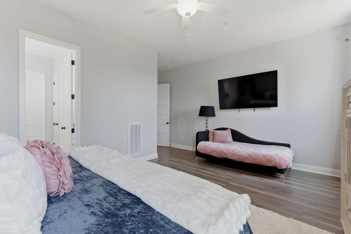 Private en suite bath features a walk-in shower with glass enclosure and clean, modern finishes