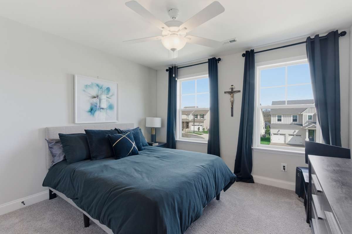 The fourth bedroom is generously sized and features two large windows that bring in beautiful natural light