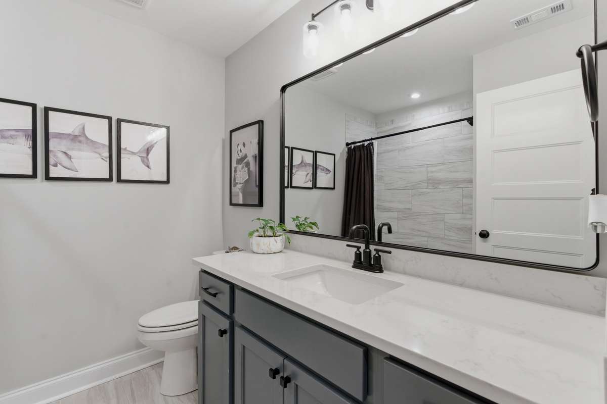 Upstairs also includes an additional full bathroom conveniently located between Bedrooms 3 and 4, offering added functionality for the layout.