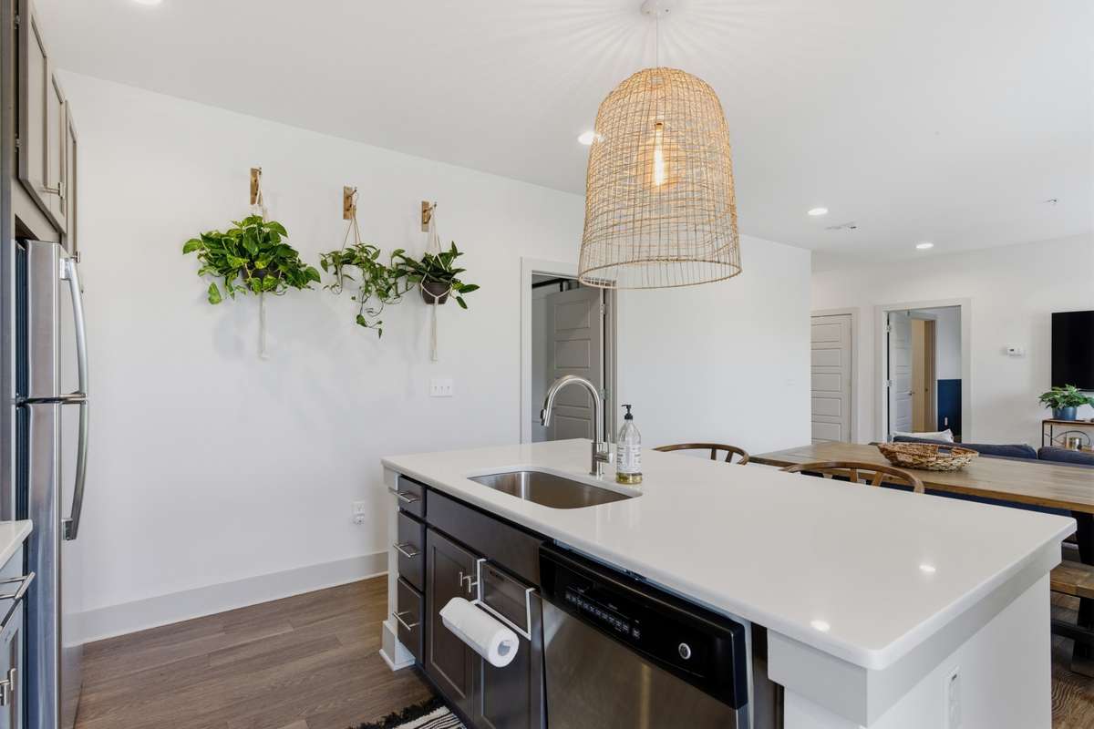 The boho chandelier and faux greenery add a pop of character and charm.