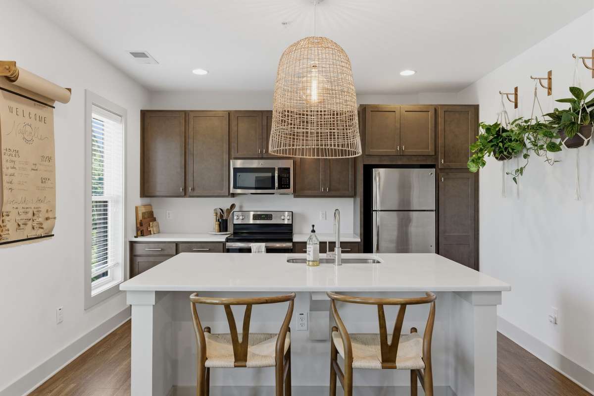 The wide quartz island doubles as a breakfast bar, perfect for enjoying a snack or your morning coffee!