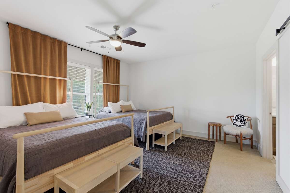 The primary bedroom is spacious enough for multiple beds, allowing you to maximize your guest count as a rental.