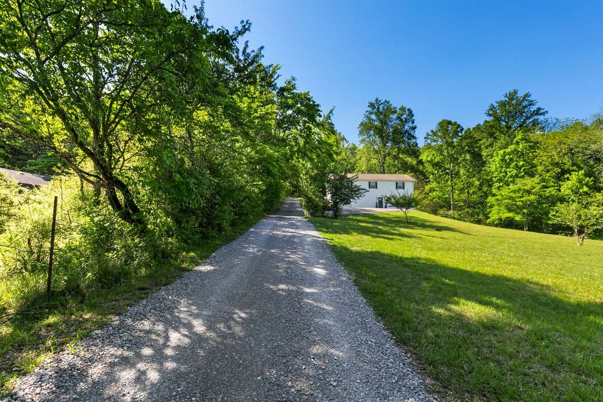 Home sits 1,000’ off road and faces the woods!