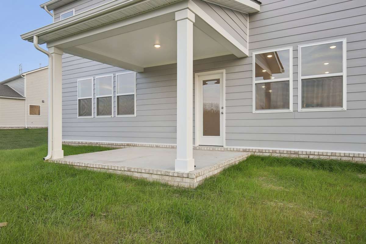 Relax under your covered rear patio, a versatile extension of your home that creates the perfect setting for indoor/outdoor entertaining.