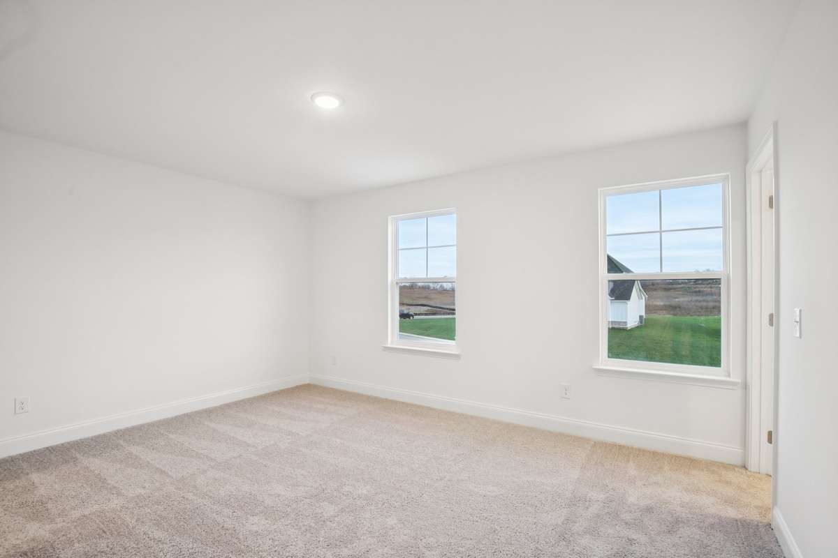 One of the spacious secondary bedrooms that features a walk-in closet and shares a well-designed Jack-and-Jill bath-offering both privacy and convenience with plenty of room to grow.