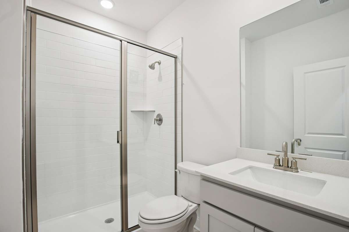 A full bathroom is located on the main level and includes a tiled walk-in shower.