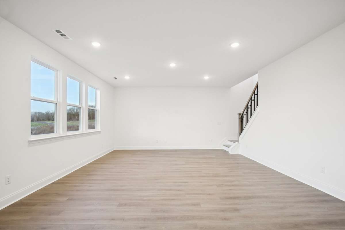 The great room features an open concept design with abundant natural light, creating an inviting atmosphere ideal for entertaining and relaxing.