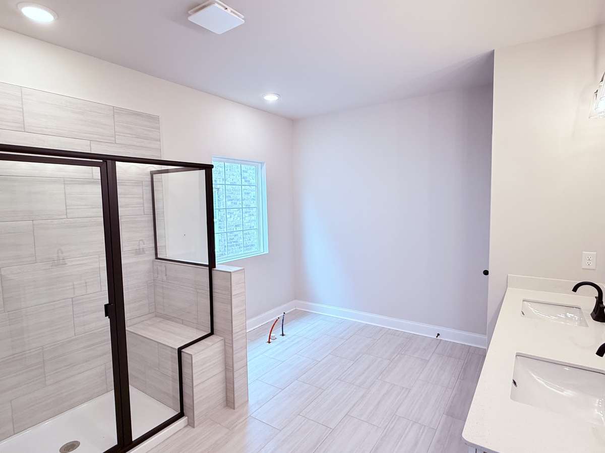 The primary bathroom includes dual sinks with quartz countertops, combining style and functionality.