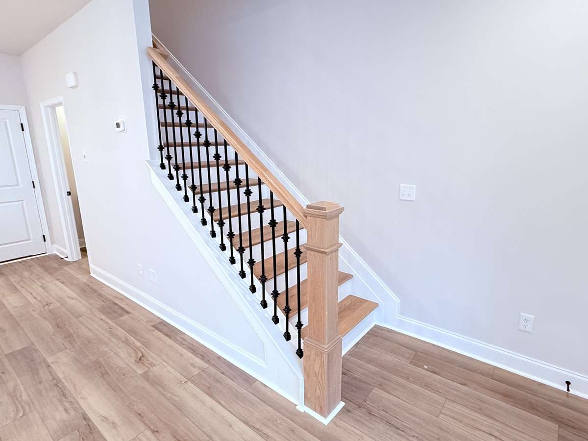Hardwood stairs with iron spindles are included, offering a sophisticated design feature that elevates the home’s overall aesthetic.