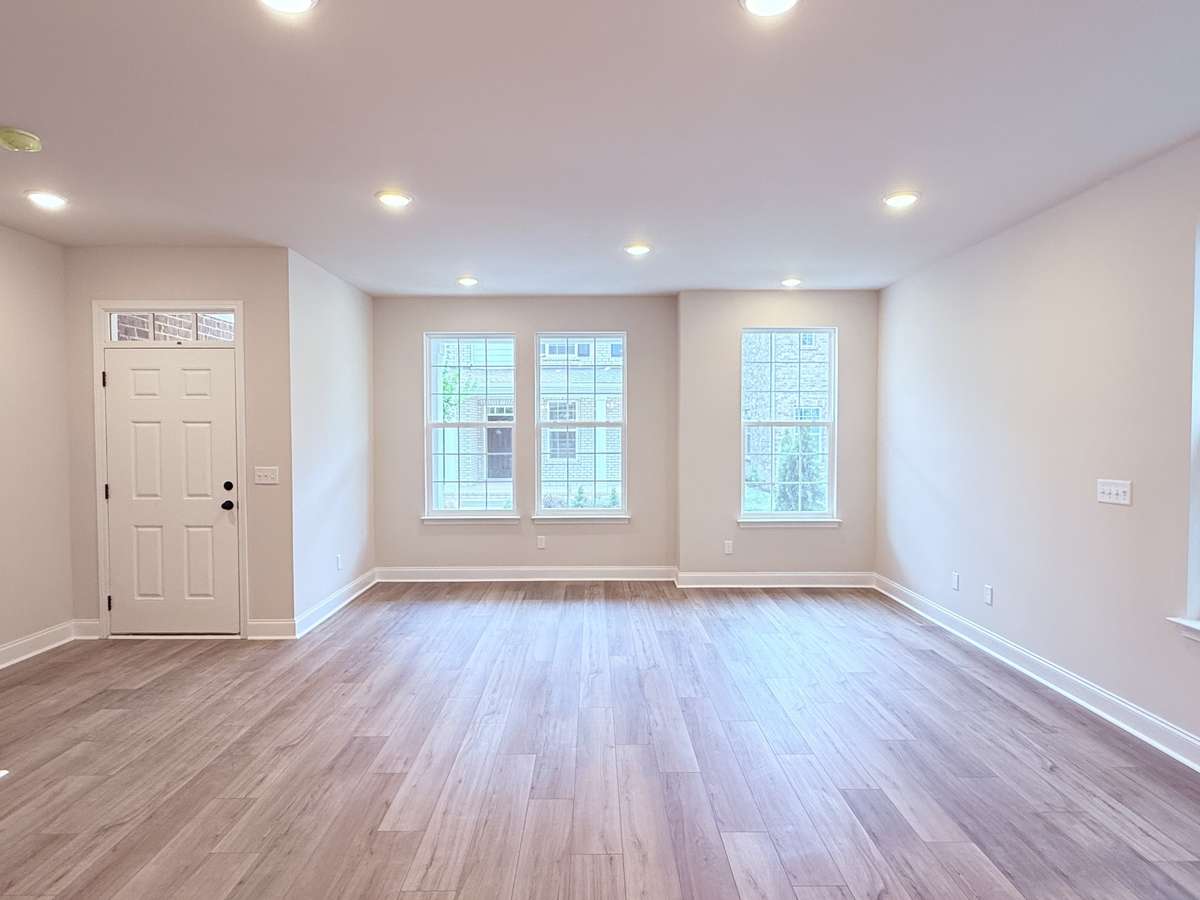 Front-facing windows offer picturesque views of the courtyard, bringing the beauty of the outdoors right into your living space.