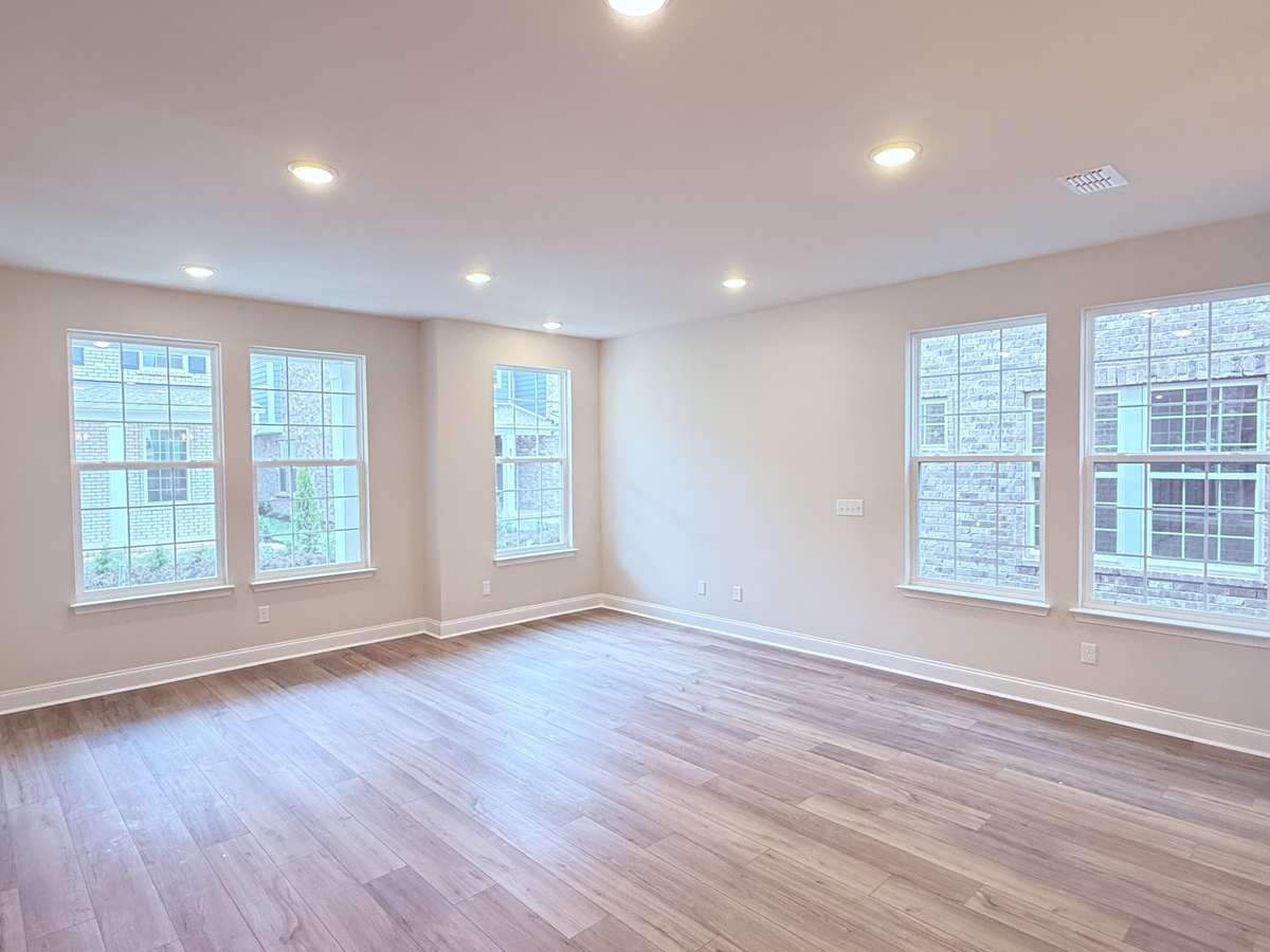 Expansive windows flood this end-unit townhouse with abundant natural light, creating a bright and welcoming living space.