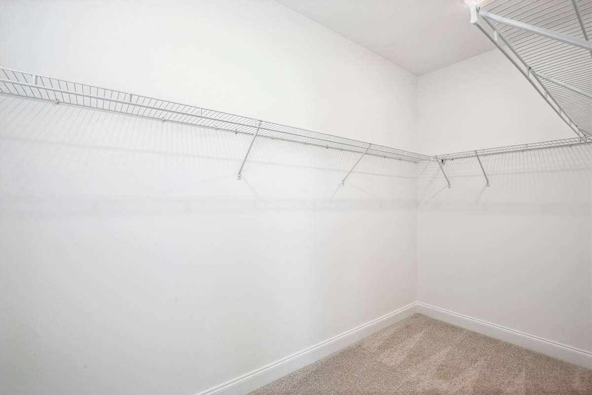 The primary suite features a roomy walk-in closet, perfect for keeping your wardrobe organized.