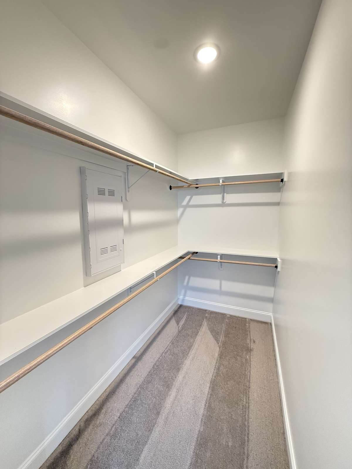 Owners' suite walk-in closet. Photos shown are of a completed home of the same floorplan and are for reference purposes only. Options and colors may vary.