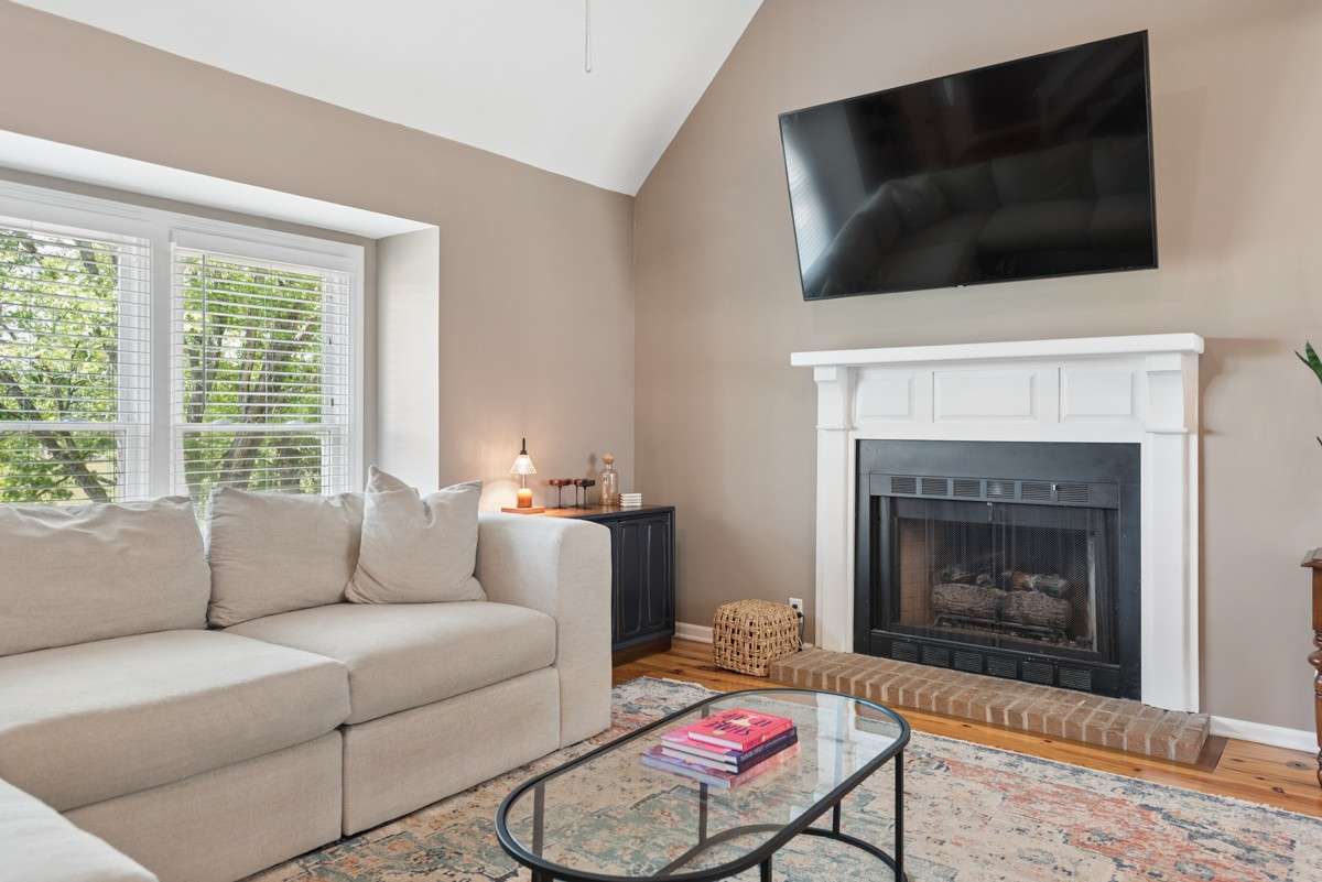 The windows have been replaced and the fireplace has gas logs but could be wood burning.