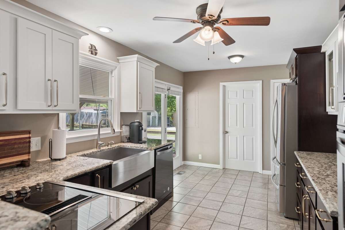 Electric cook top, stainless farmhouse sink and tiled flooring will make the chef very happy.