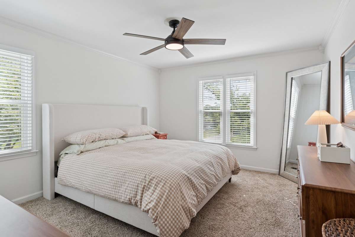 The owner's suite is on the main level with great natural light and space.  The blinds are already bought and installed - yay!!