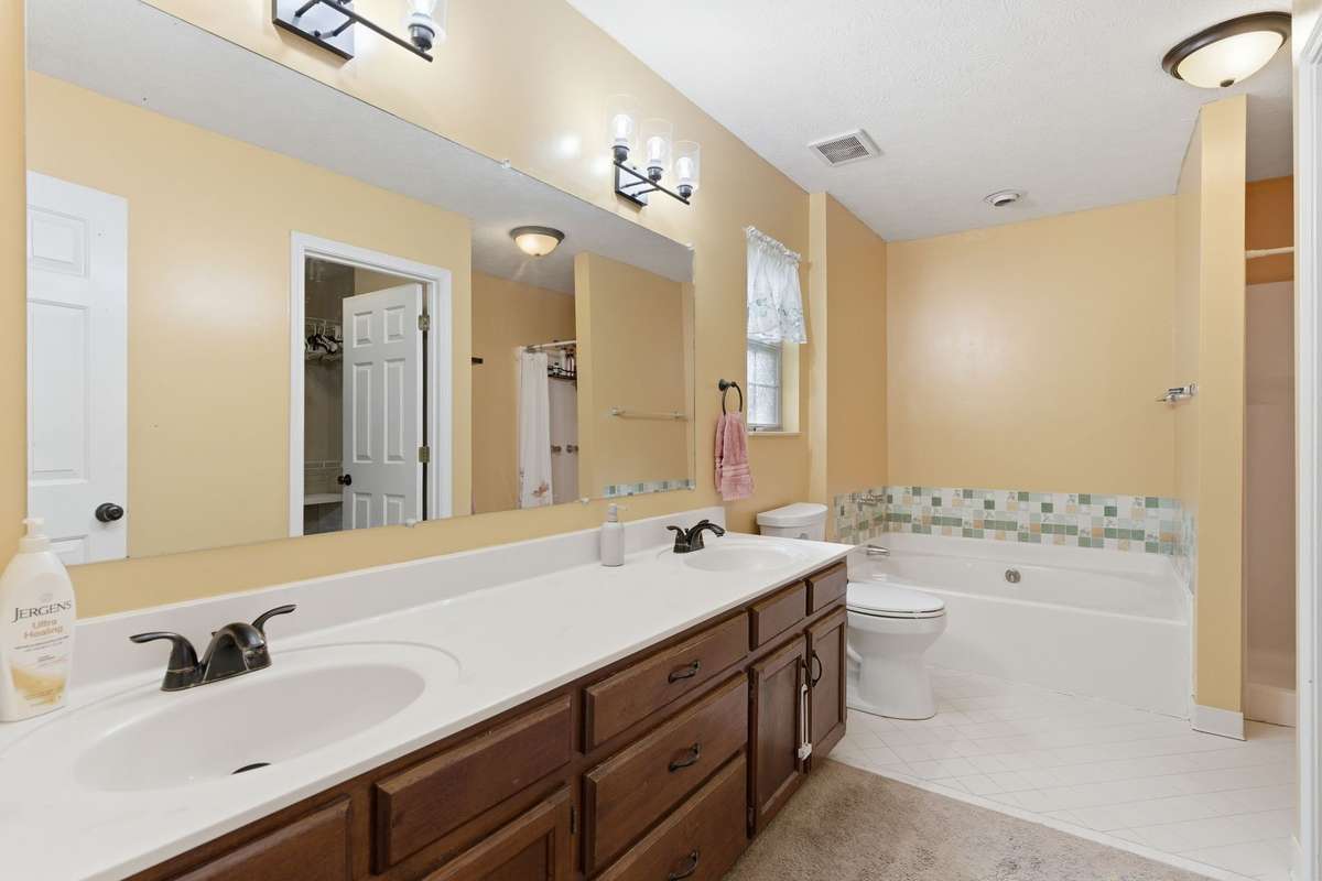 Double vanity with separate tub and shower.