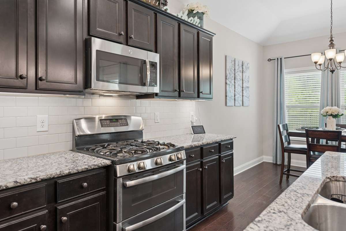 Gas range featuring a double oven underneath and gas burners above.