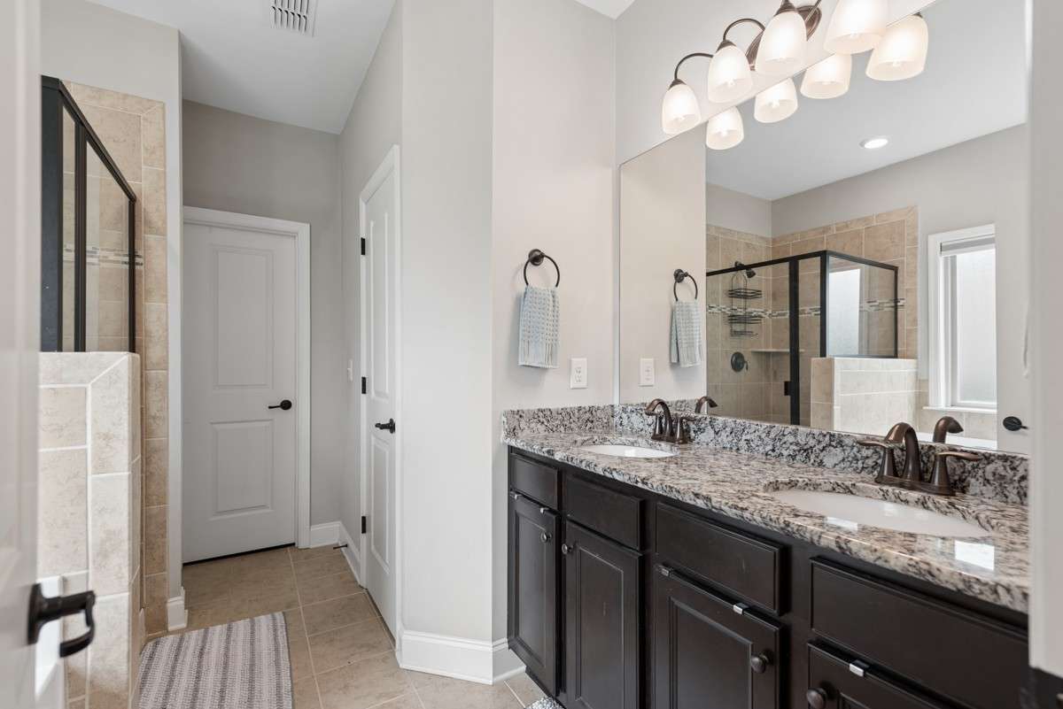 en-suite bathroom includes garden tub, tile shower, double vanity, and a huge walk-in closet.