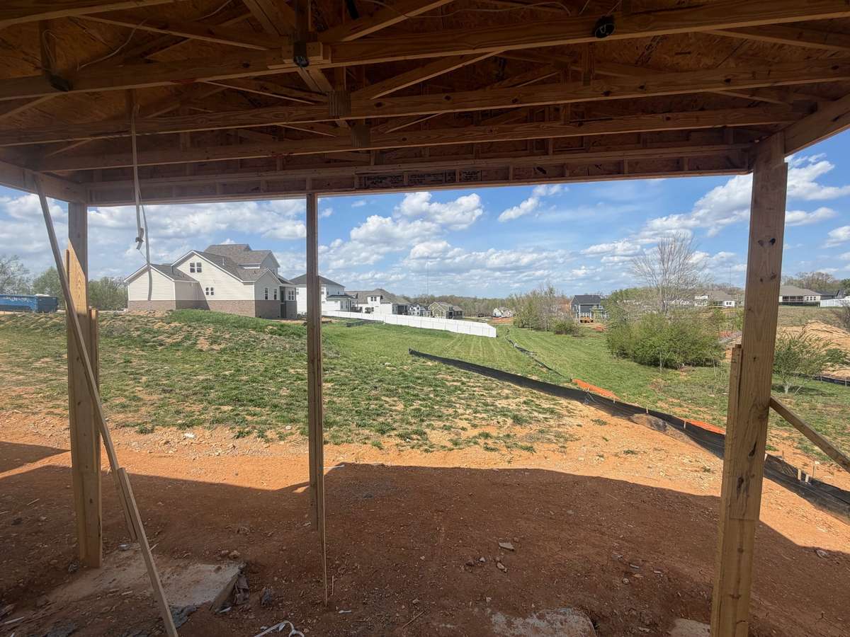 LARGE COVERED PORCH AREA LOOKS ON TO BIG BACK YARD