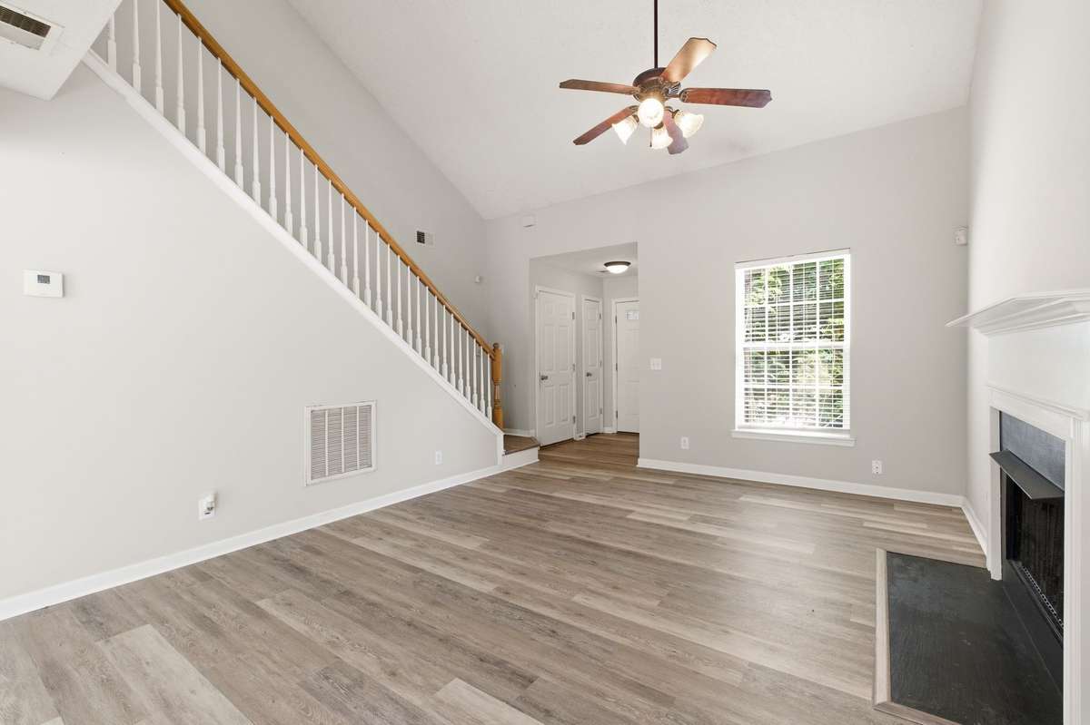 View from the living room highlighting the seamless flow from the entryway and staircase.