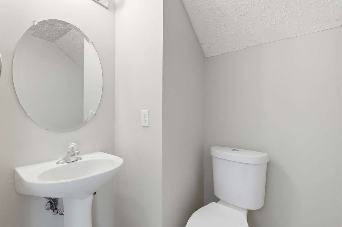 Convenient main-level half bathroom featuring a classic pedestal sink