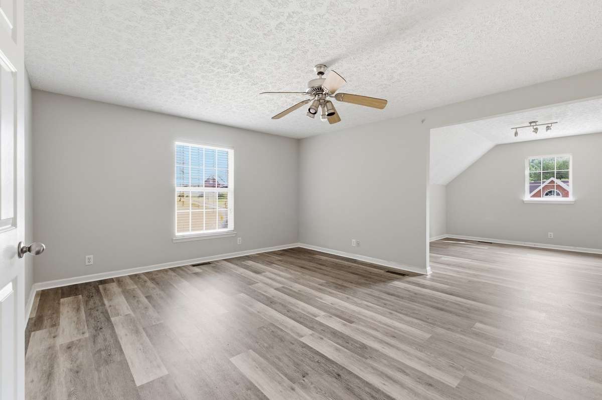 Large, versatile bonus room with great natural light, perfect for a home office or playroom