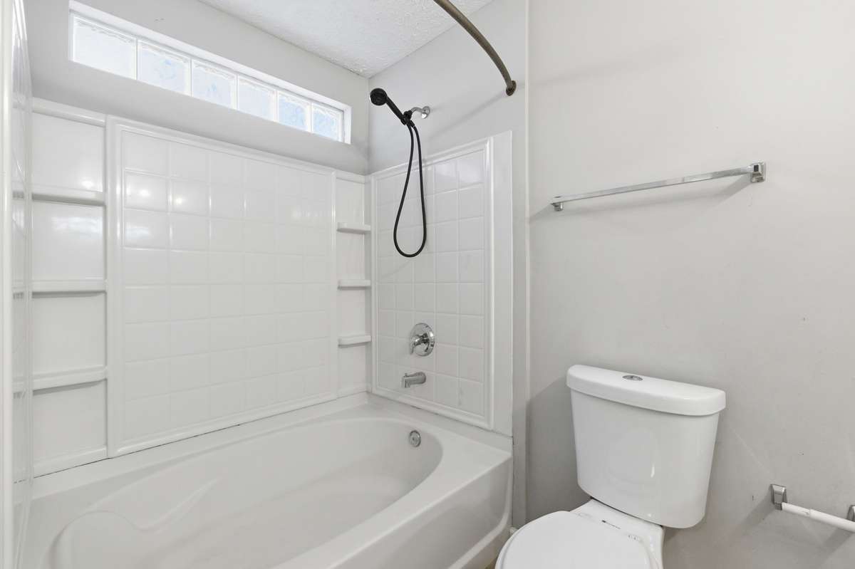 Oversized tub and shower combination with built-in shelving in the Master Bathroom.