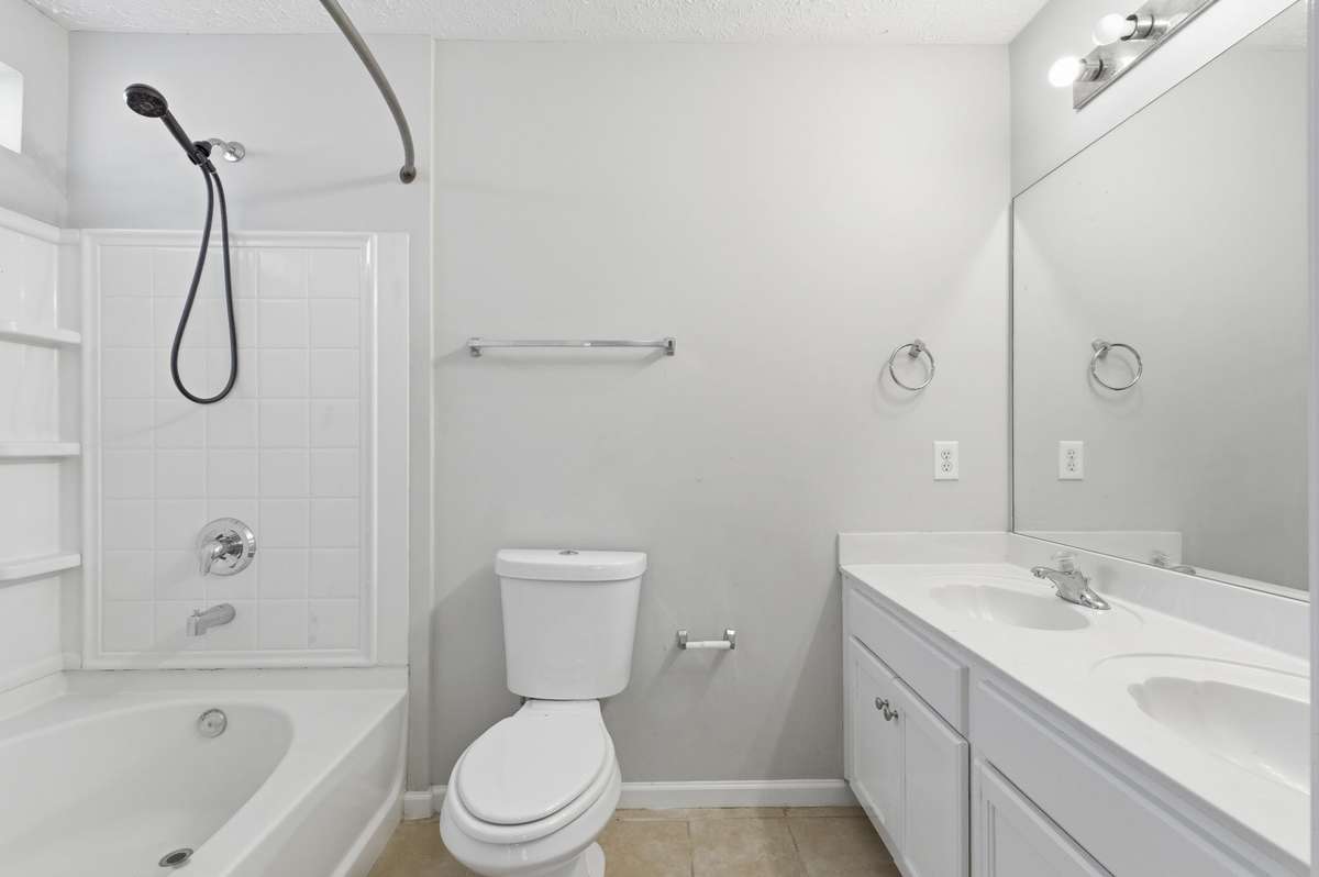 Master en-suite bathroom featuring a double vanity and an oversized soaking tub.
