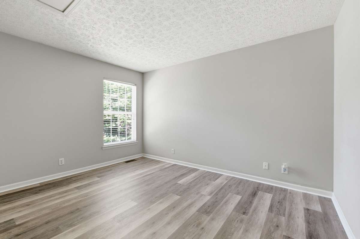 Generously sized secondary bedroom featuring large window, and new LVP flooring.