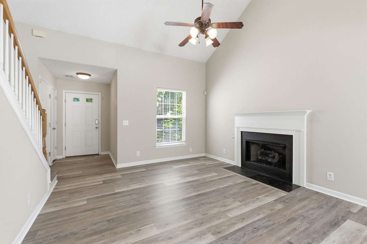 Cozy gas fireplace anchoring the light-filled living room with fresh paint