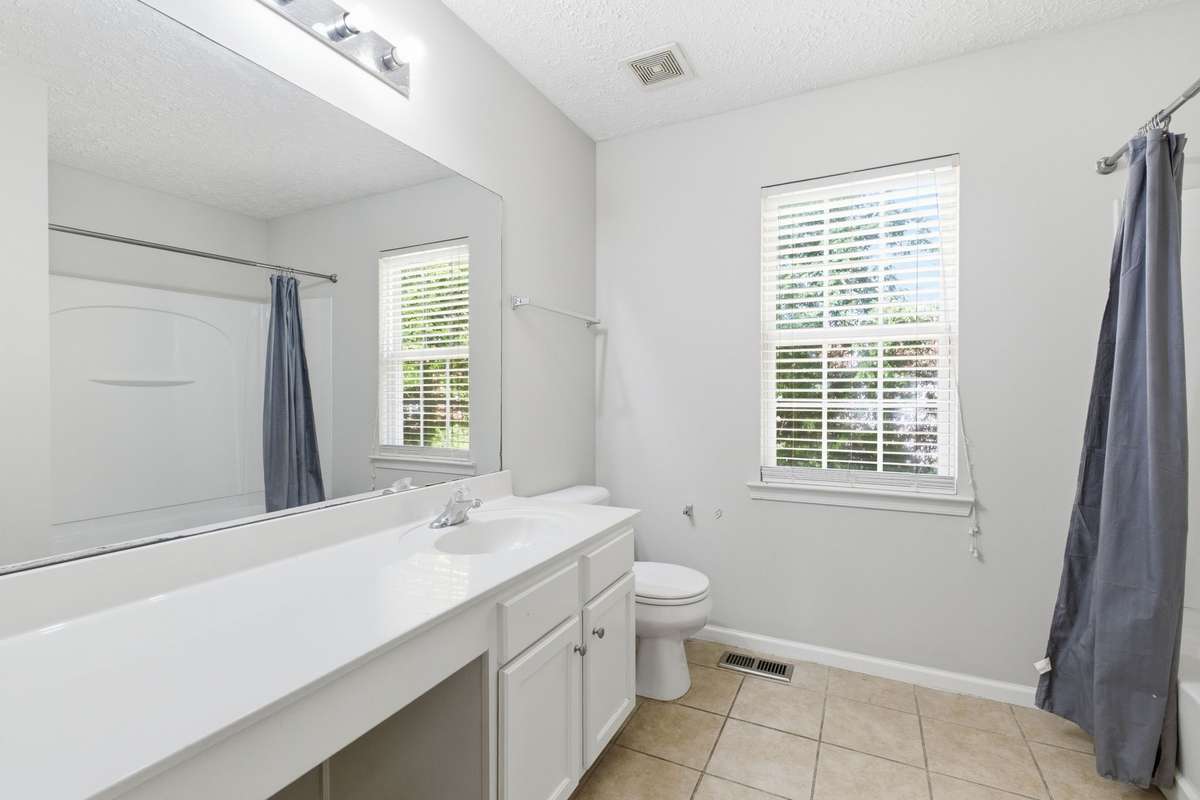 Secondary bedroom showing ample double-door closet space