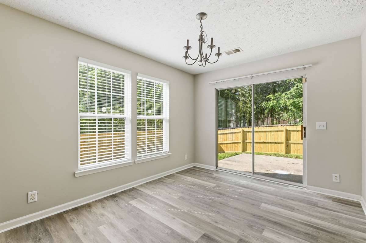 Bright dining area overlooking the private, fenced backyard