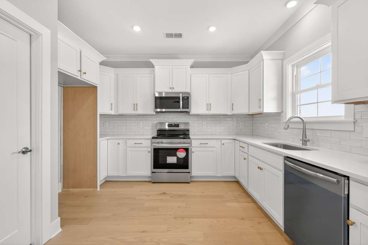 Kitchen with stainless steel appliances and quartz countertops