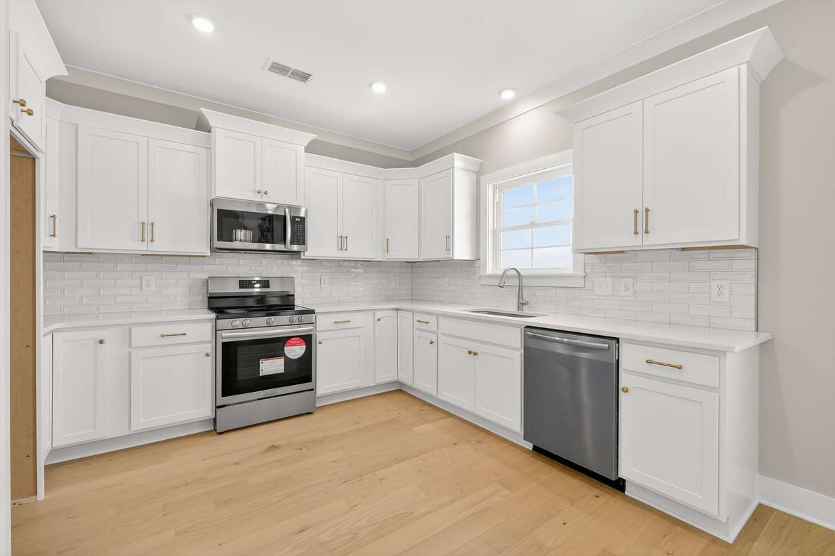 Kitchen with stainless steel appliances and quartz countertops