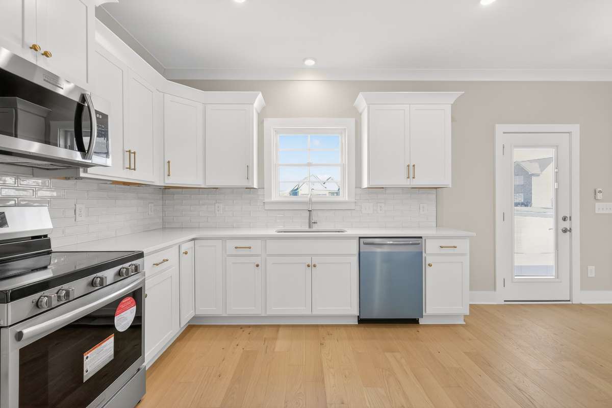 Kitchen with stainless steel appliances and quartz countertops