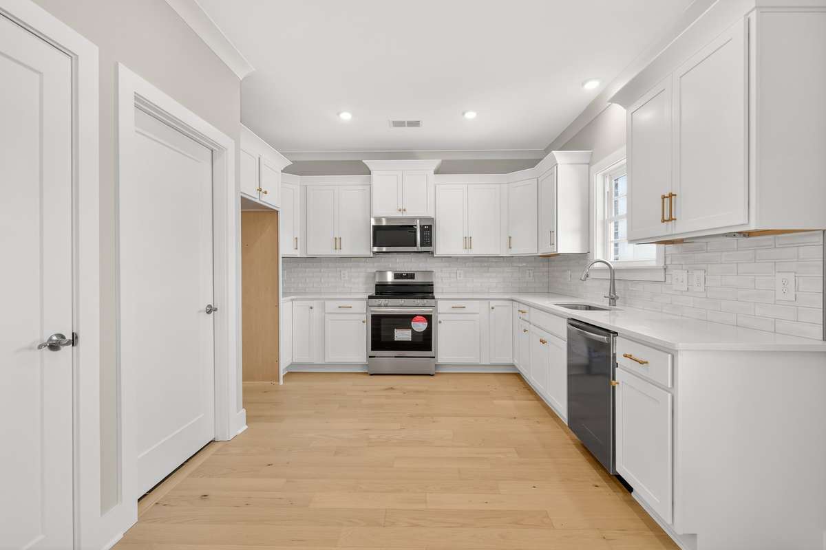 Kitchen with stainless steel appliances and quartz countertops