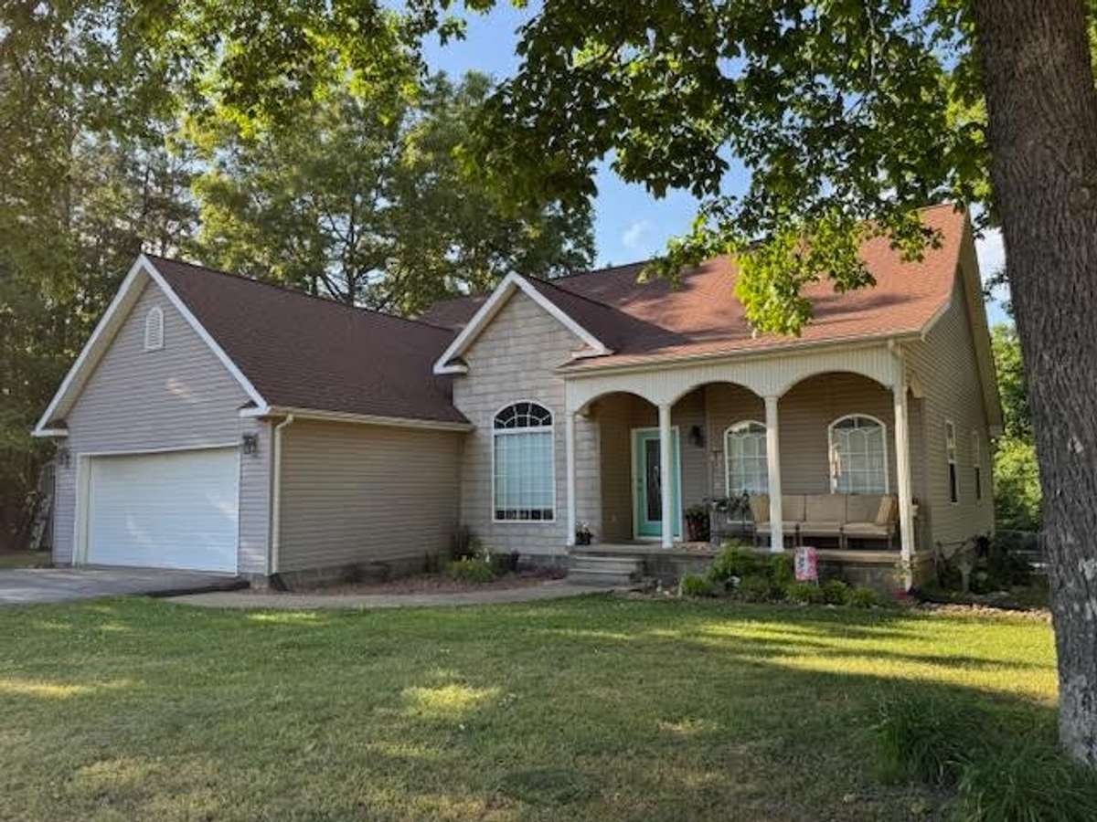 Covered front porch, 2 Car attached Garage, and Mature Trees!