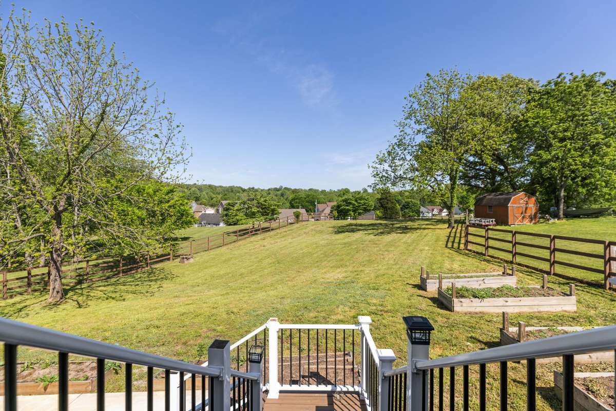Large Back yard with concrete patio below. Great area for hosting!
