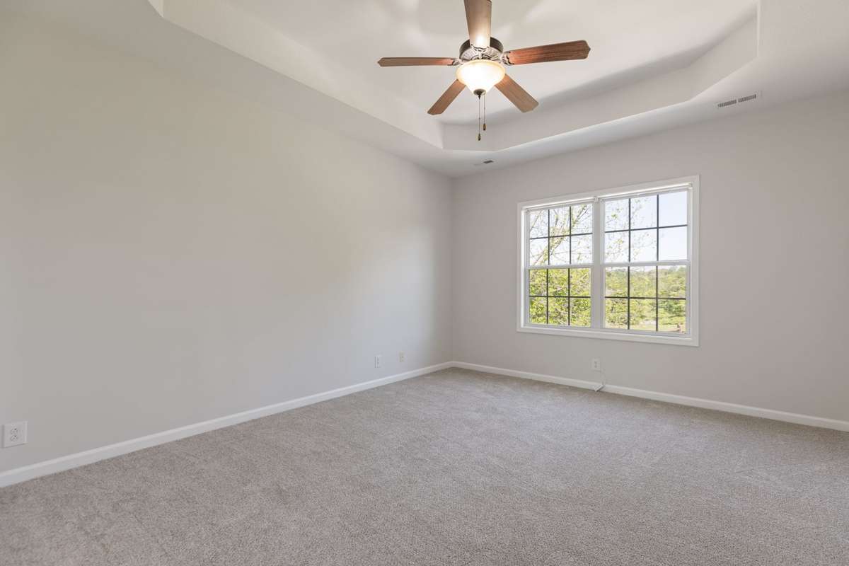 Primary Bedroom with tray ceiling and ensuite bath