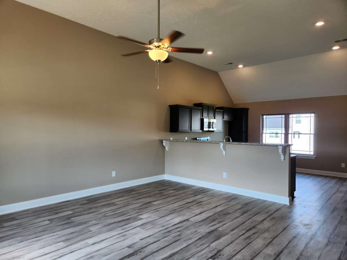 Kitchen features a Granite Bar Top for Serving and additional Dining Space!