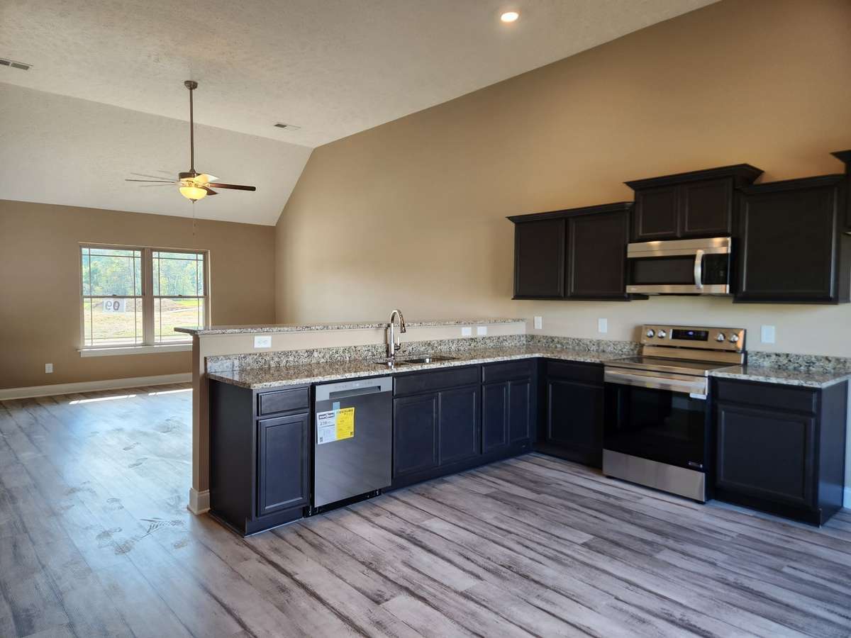 Vaulted Ceiling in the Living Room and Kitchen. Builder provides upgraded Stainless Stove with Convection Oven & Air Fryer, Microwave and Dishwasher.