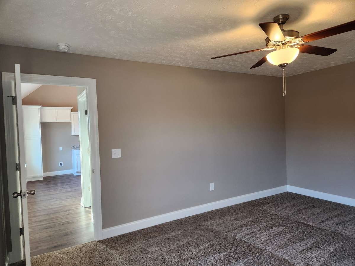 Extra Wall Space and Ceiling Fan in the Primary Bedroom.  Picture of Previous House.