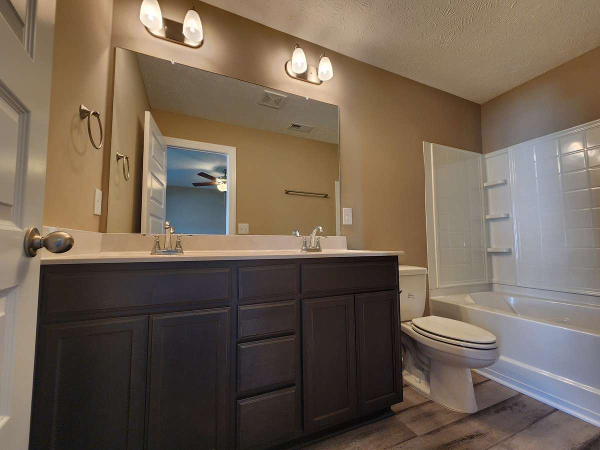 Custom Cabinets and Waterproof LV Plank Flooring in Primary Bath.