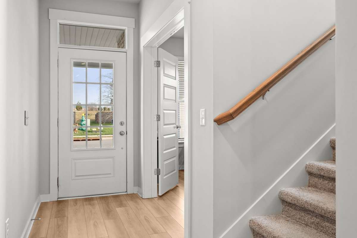 Front door, office entry, and steps to the second level.
