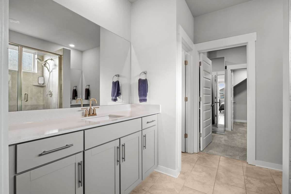 There are two separate vanity areas. You can see the seperate toilet room, main walk-in closet, and additional closet beyond that.