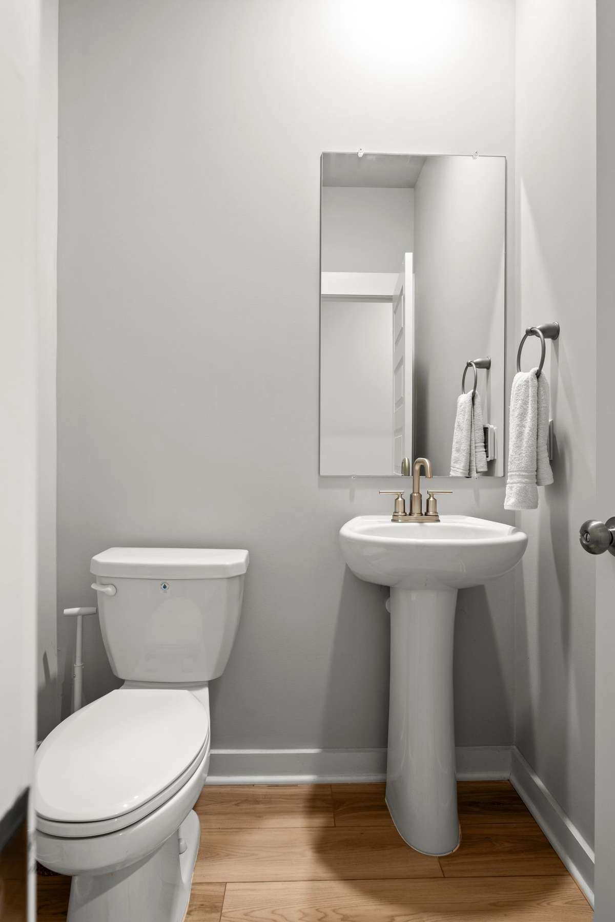The half bath is located next to the stairs.