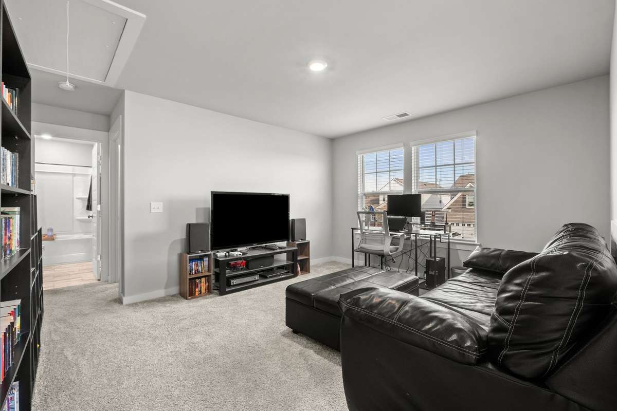 Another view of the recreation room. You can see one of the upstairs full baths at the end of the hall.
